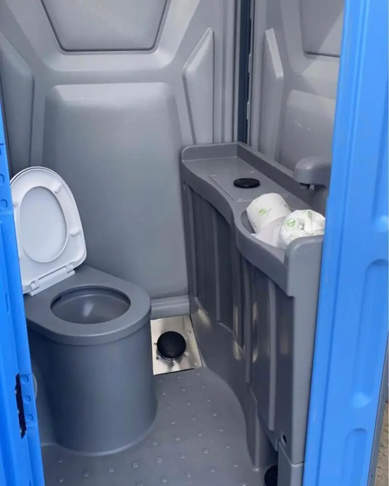 Inside a deluxe porta potty with sink