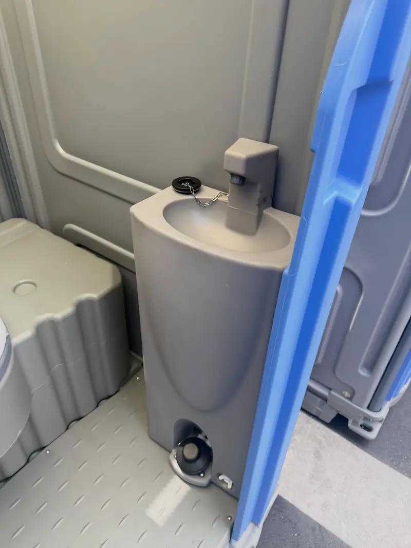 Spacious porta potty interior with sink